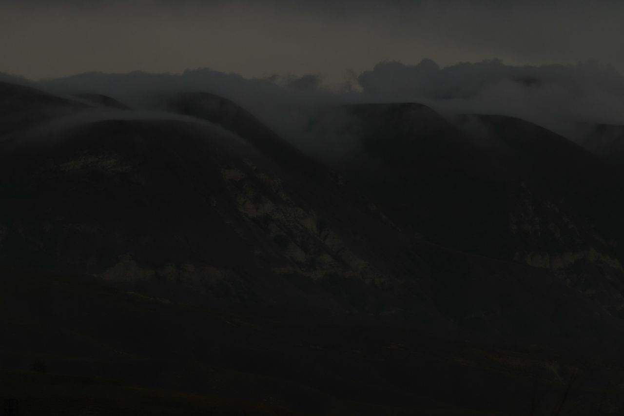 Misty mountain peaks at dusk